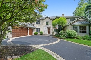 1016 Seneca Road Wilmette, IL 60091 - Photo 1 of 1 a front view of a house with a yard and garage