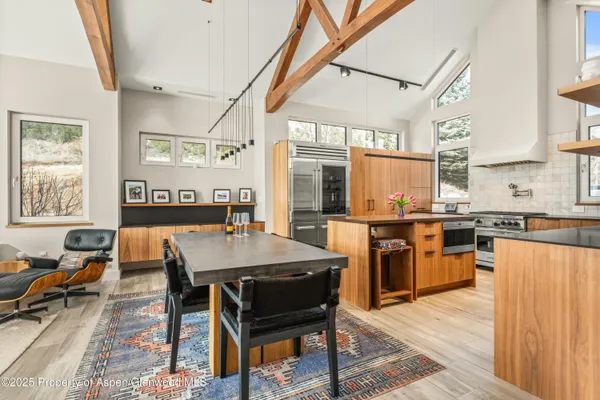 a large kitchen with a table and chairs