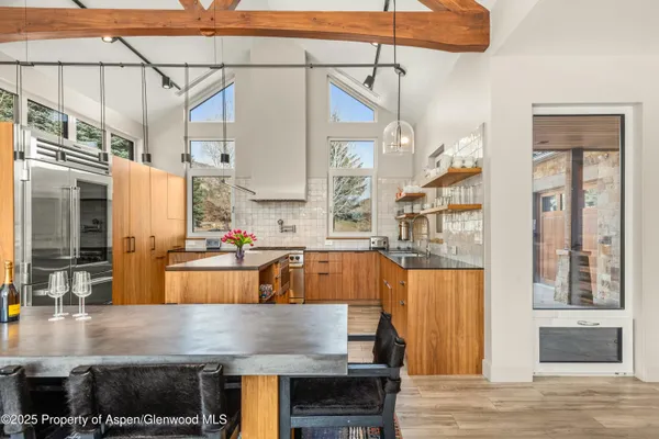 a kitchen with stainless steel appliances granite countertop a stove and refrigerator