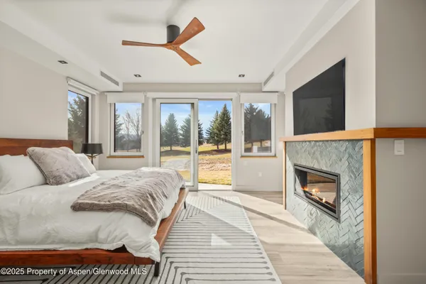 a bedroom with a bed and a fireplace