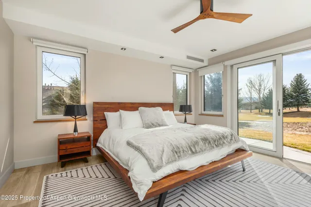 a bedroom with a bed and a large window