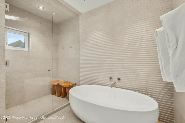a bathroom with a white bath tub and a white door