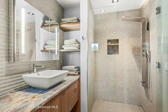 a bathroom with a granite countertop sink and a mirror