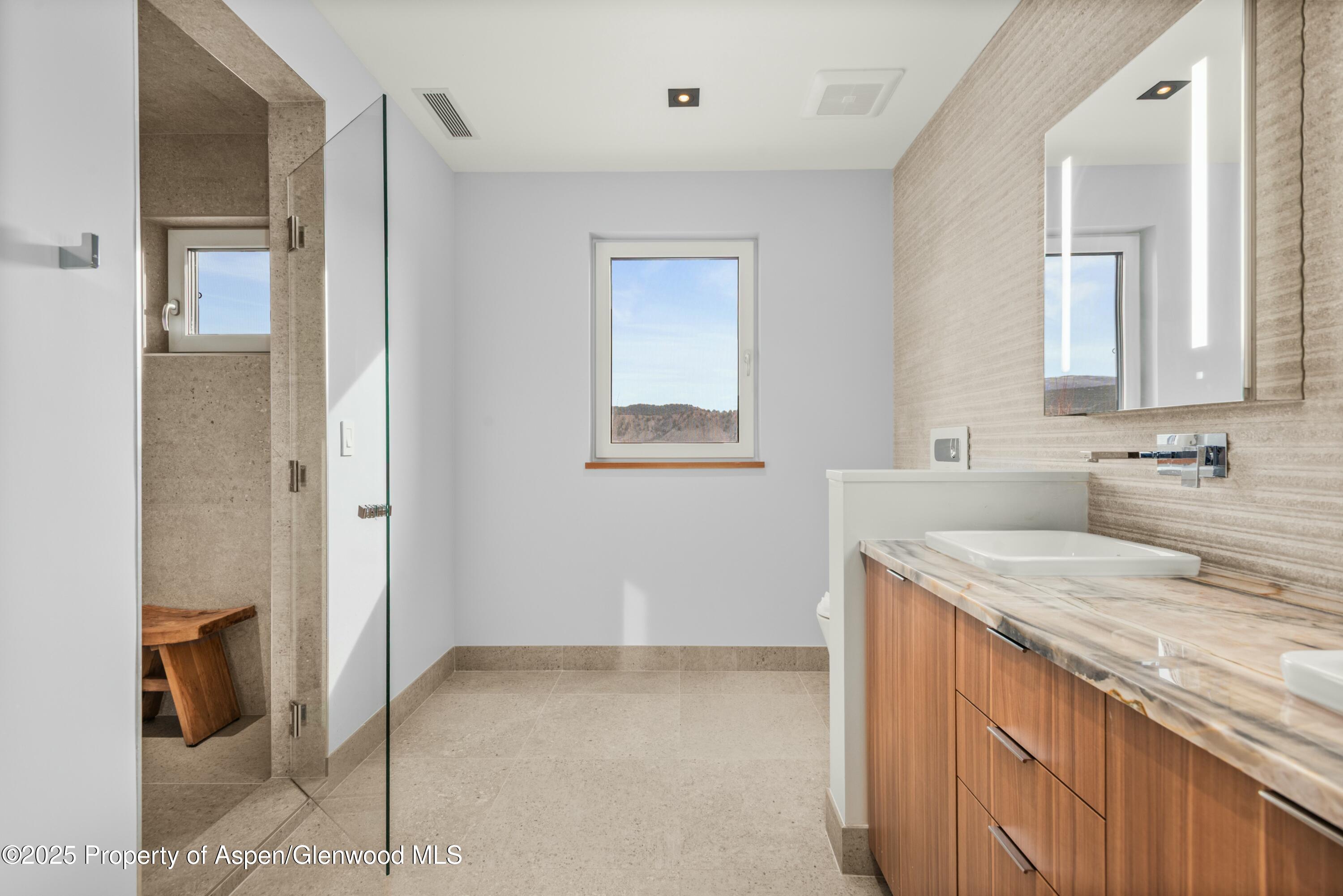 649 Saddleback Road Carbondale, CO 81623 - Photo 27 of 37 a bathroom with a granite countertop sink and a mirror