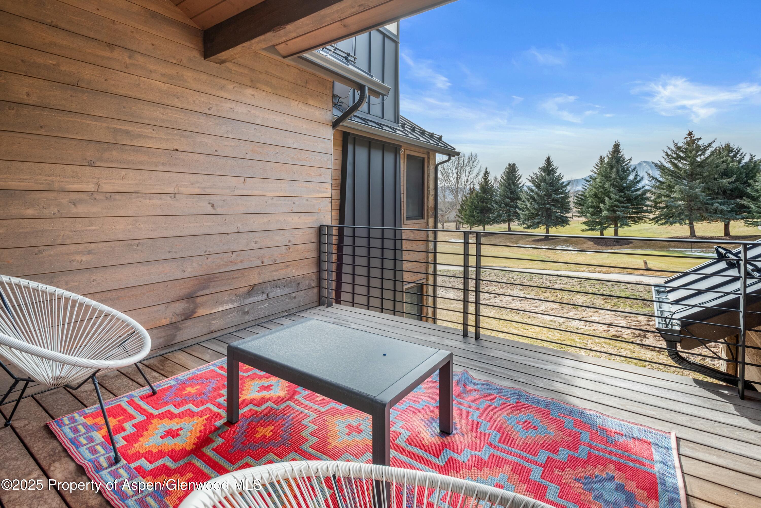 649 Saddleback Road Carbondale, CO 81623 - Photo 32 of 37 a view of a balcony with two chairs and a potted plant