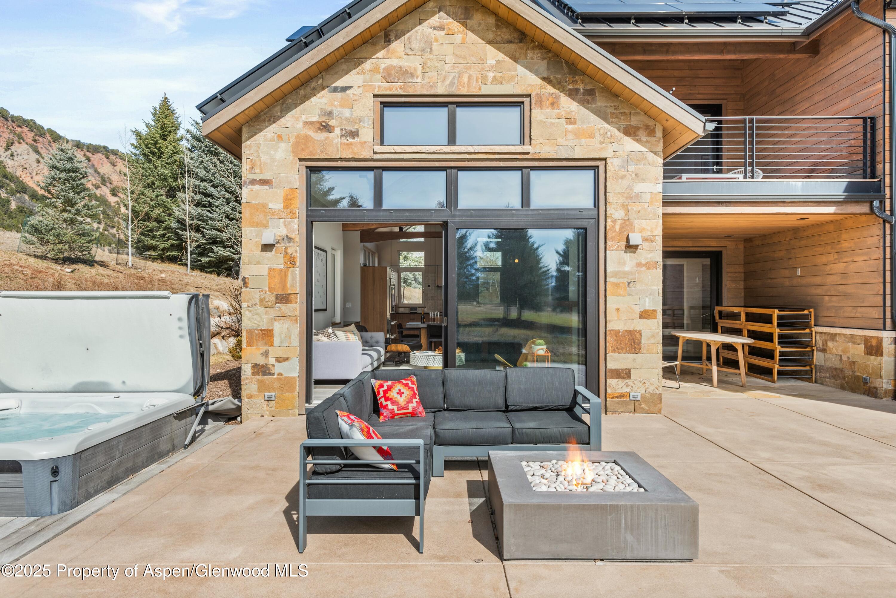 649 Saddleback Road Carbondale, CO 81623 - Photo 4 of 37 a view of a patio with couches and table and chairs with wooden floor and fence