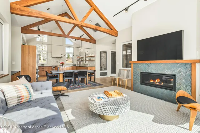 a living room with furniture a fireplace and a flat screen tv