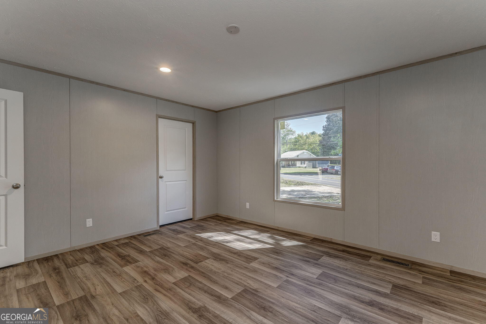 865 Old Rockmart Road Southeast Silver Creek, GA 30173 - Photo 15 of 52 a view of an empty room with wooden floor and a window