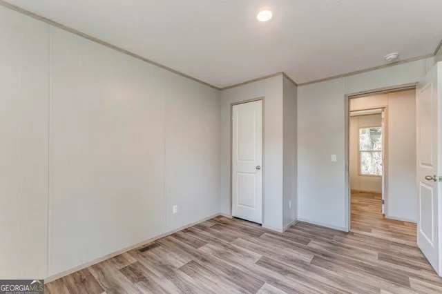 a view of a livingroom with wooden floor and closet
