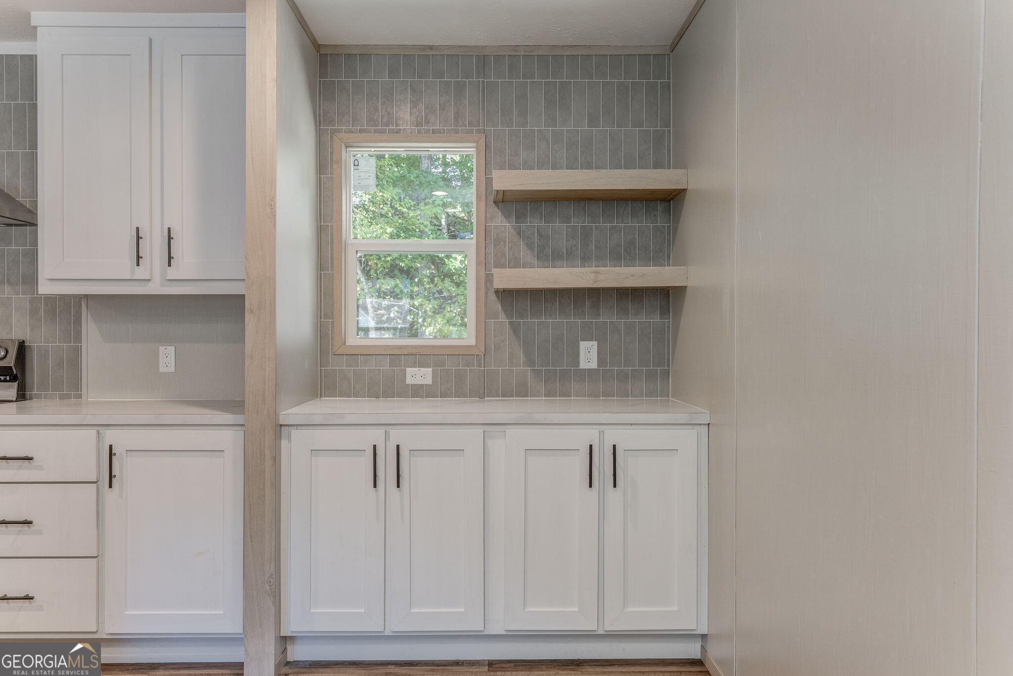 865 Old Rockmart Road Southeast Silver Creek, GA 30173 - Photo 44 of 52 a kitchen with granite countertop white cabinets and a window