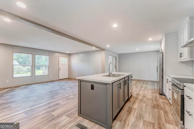 a kitchen with sink stove and cabinets