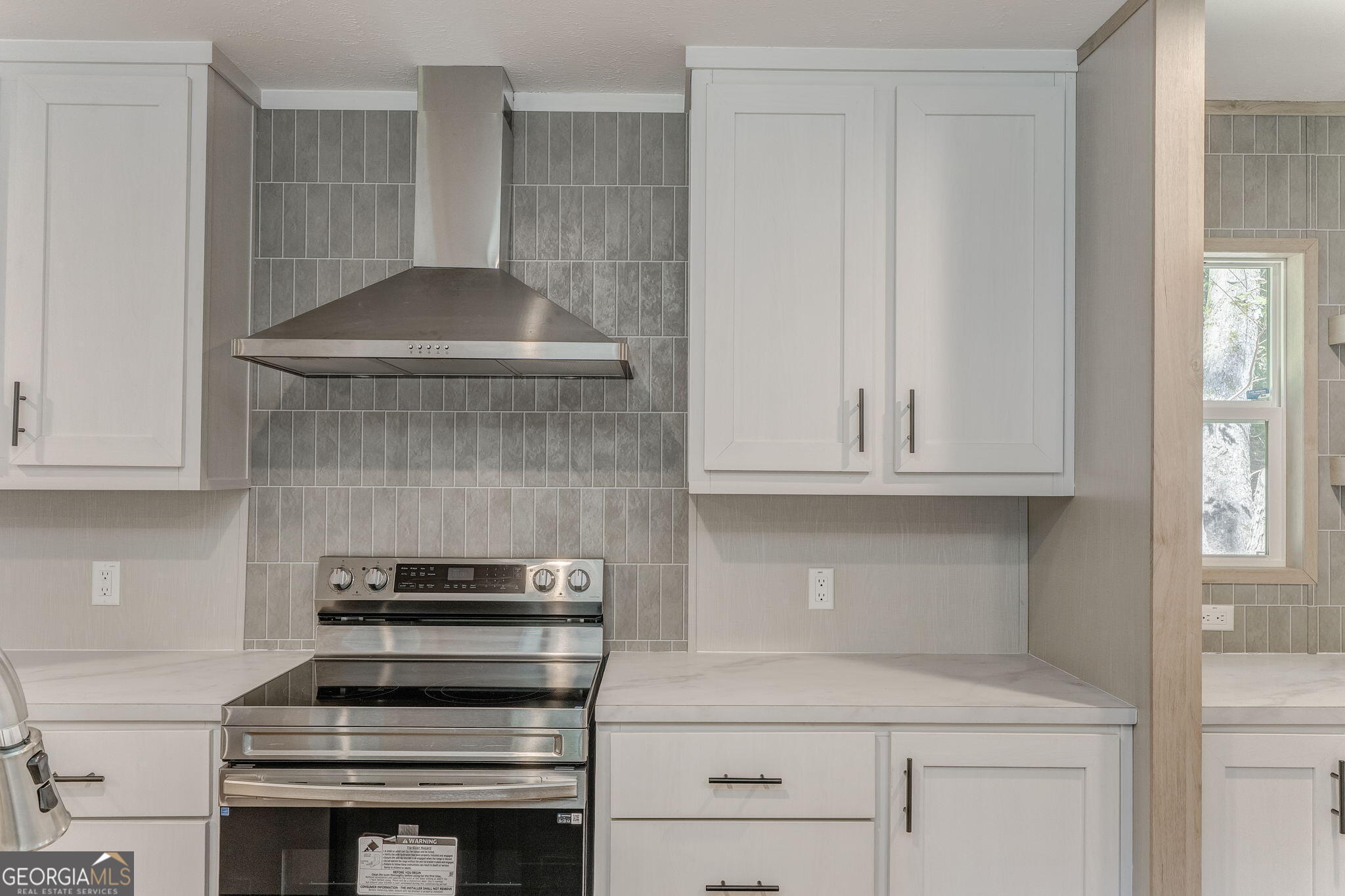 865 Old Rockmart Road Southeast Silver Creek, GA 30173 - Photo 51 of 52 a kitchen with a stove and white cabinets