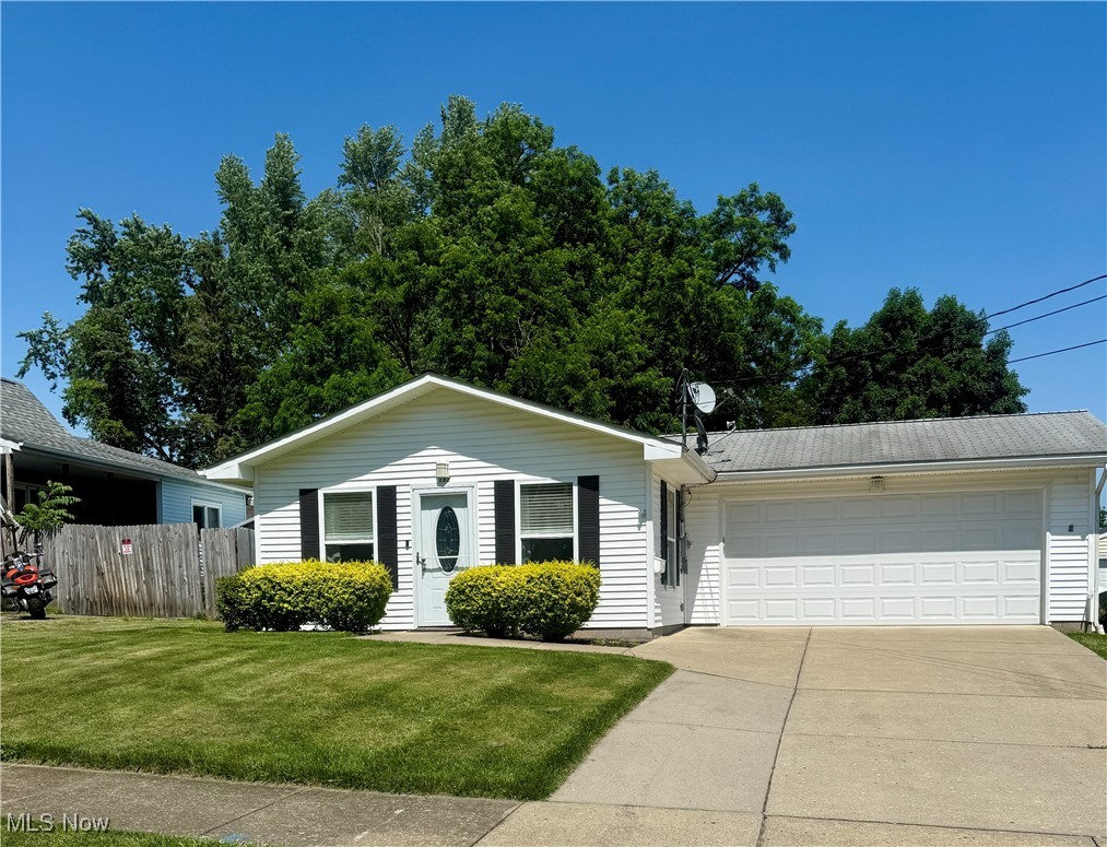 182 Perry Street Struthers, OH 44471 - Photo 1 of 9 View of front of house featuring concrete driveway and a garage