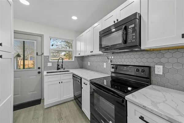 a kitchen with a stove and a microwave