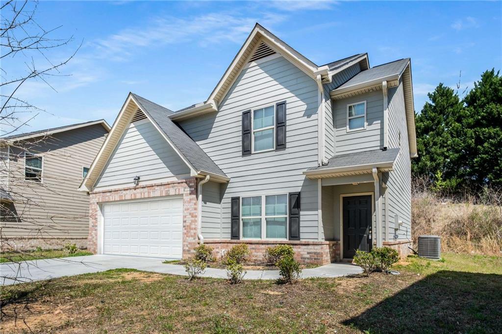 a front view of a house with a yard and garage