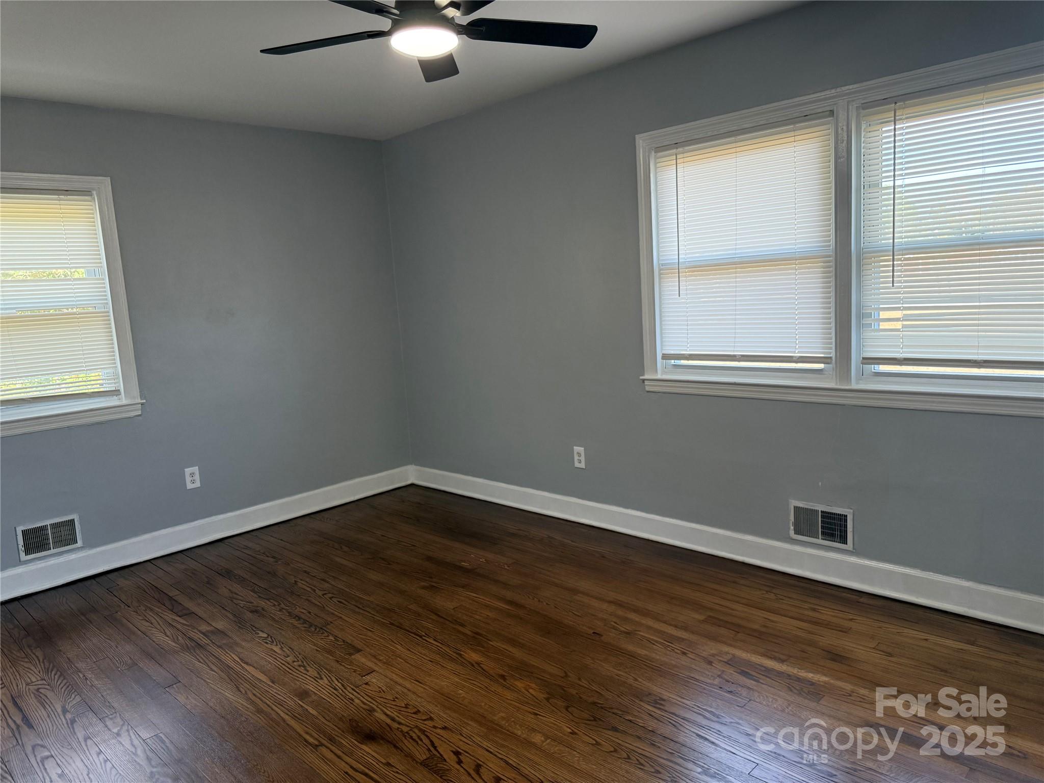 305 Tec Road Cheraw, SC 29520 - Photo 11 of 21 an empty room with wooden floor and windows