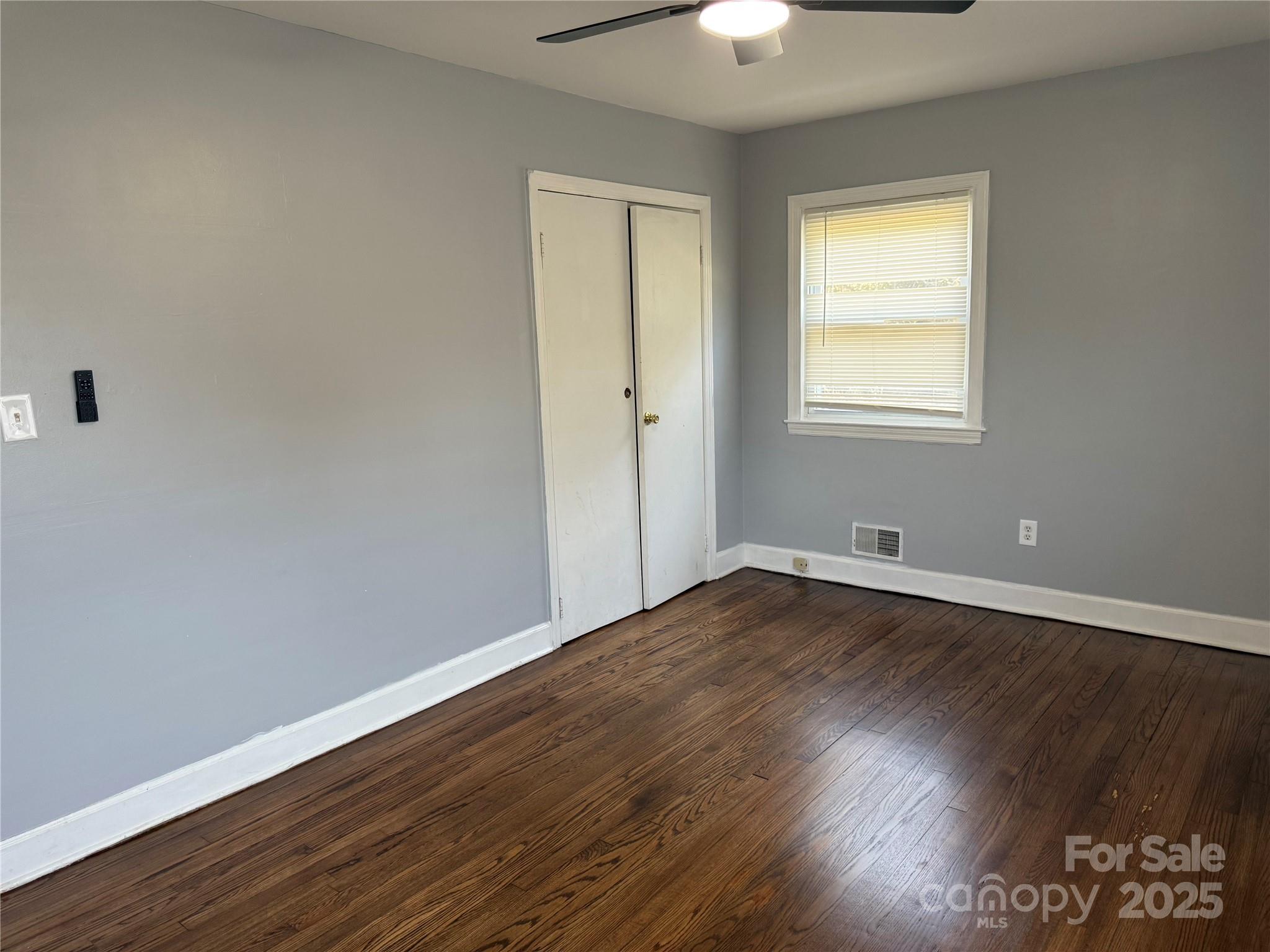 305 Tec Road Cheraw, SC 29520 - Photo 12 of 21 an empty room with wooden floor and windows