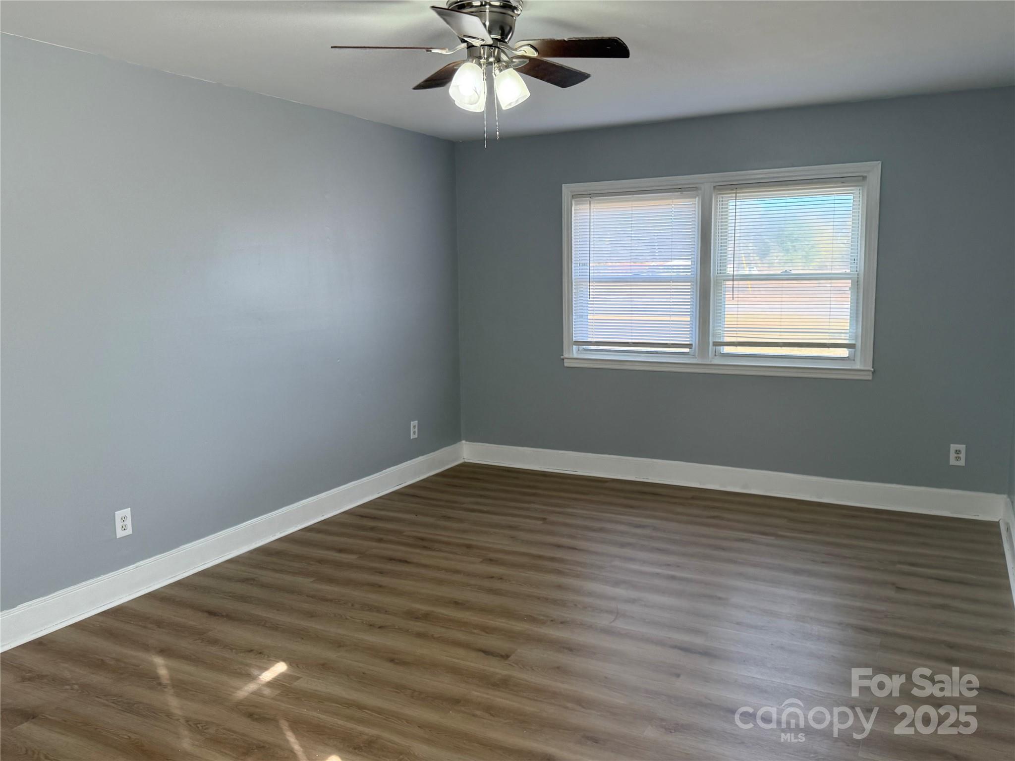 305 Tec Road Cheraw, SC 29520 - Photo 3 of 21 a view of an empty room with wooden floor and a window