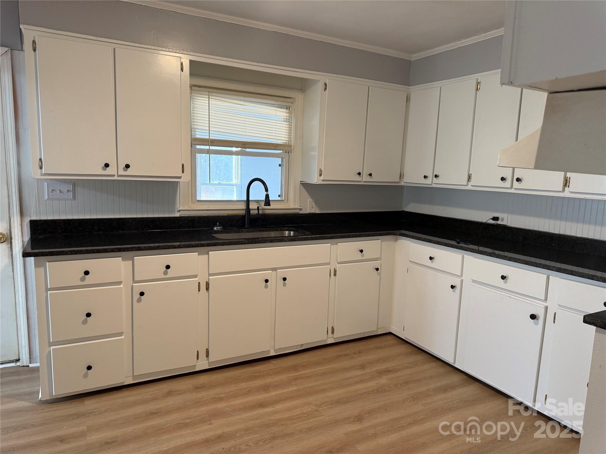 305 Tec Road Cheraw, SC 29520 - Photo 8 of 21 a kitchen with granite countertop white cabinets and a sink