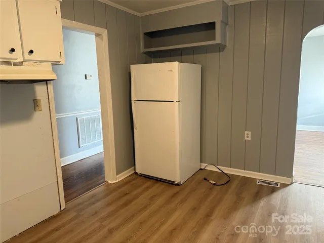 a view of a storage and utility room with wooden floor