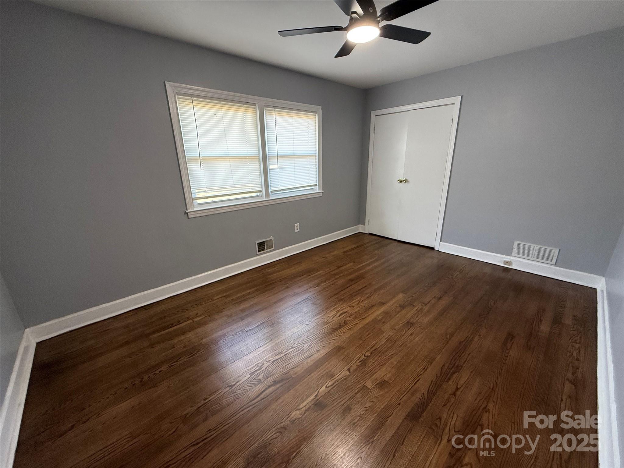 305 Tec Road Cheraw, SC 29520 - Photo 10 of 21 a view of an empty room with wooden floor and a window