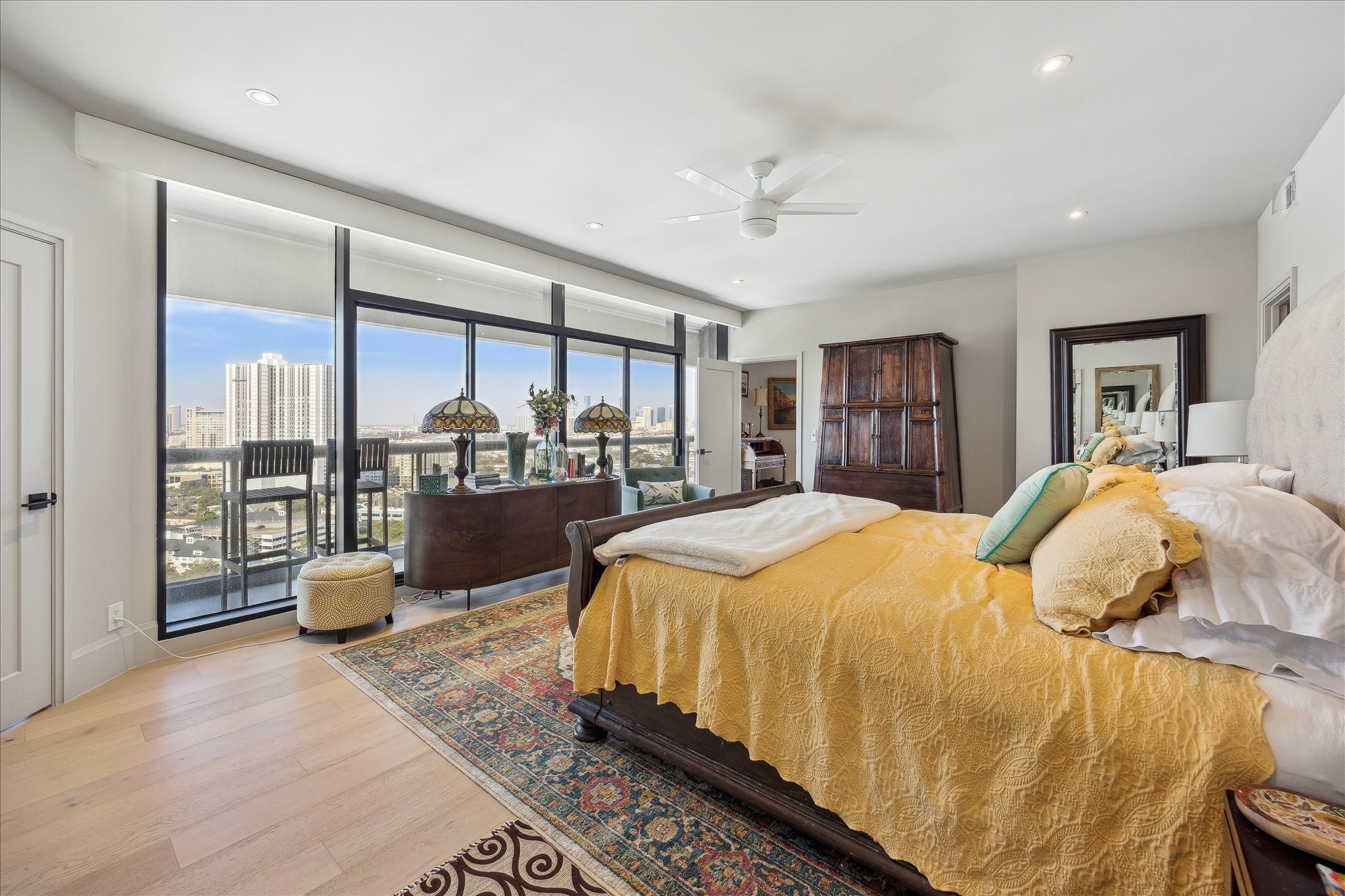 1701 Hermann Drive, Unit 22CE Houston, TX 77004 - Photo 10 of 37 a bedroom with a large bed and large windows