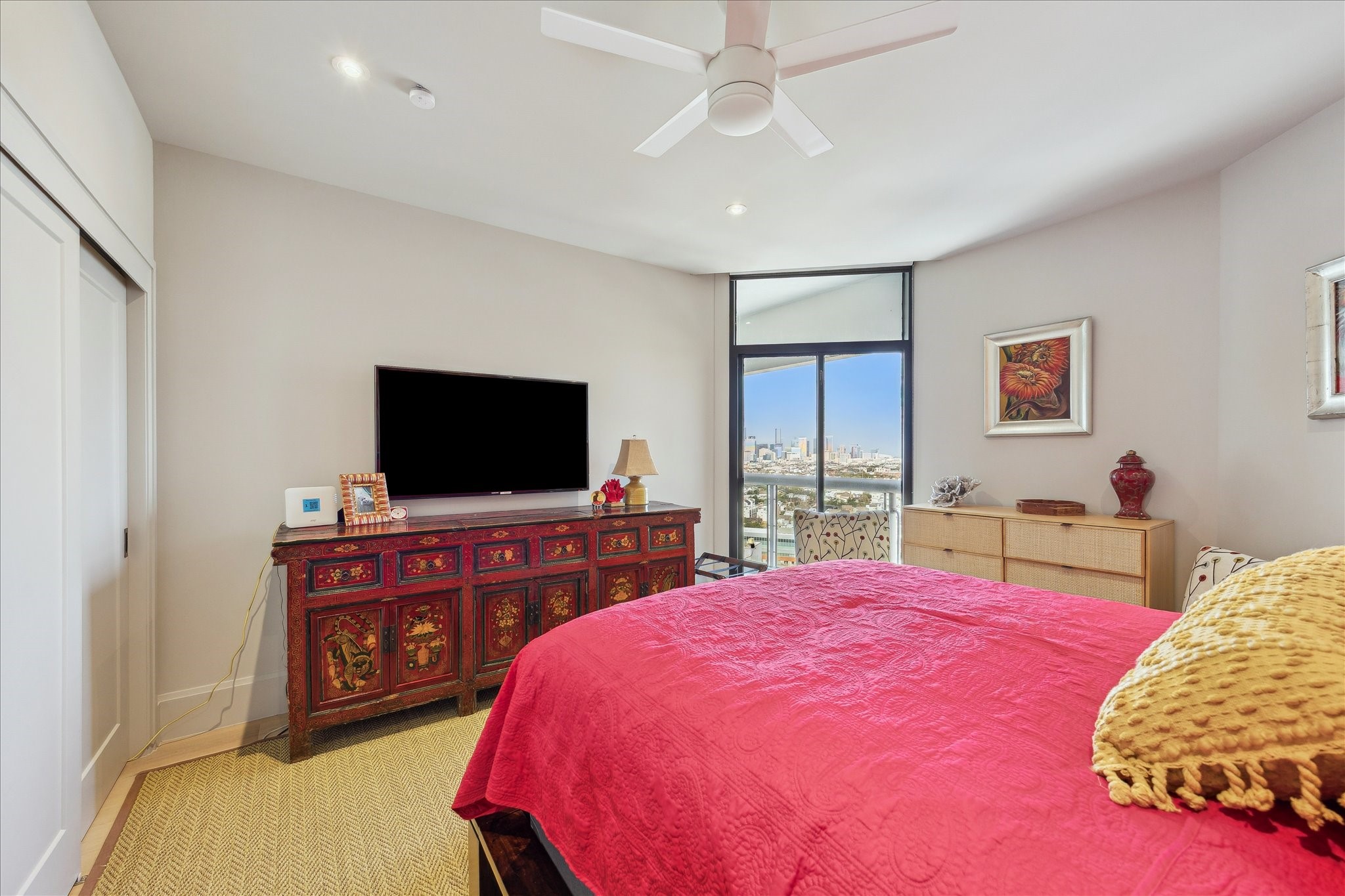 1701 Hermann Drive, Unit 22CE Houston, TX 77004 - Photo 15 of 37 a bedroom with a bed and a flat screen tv