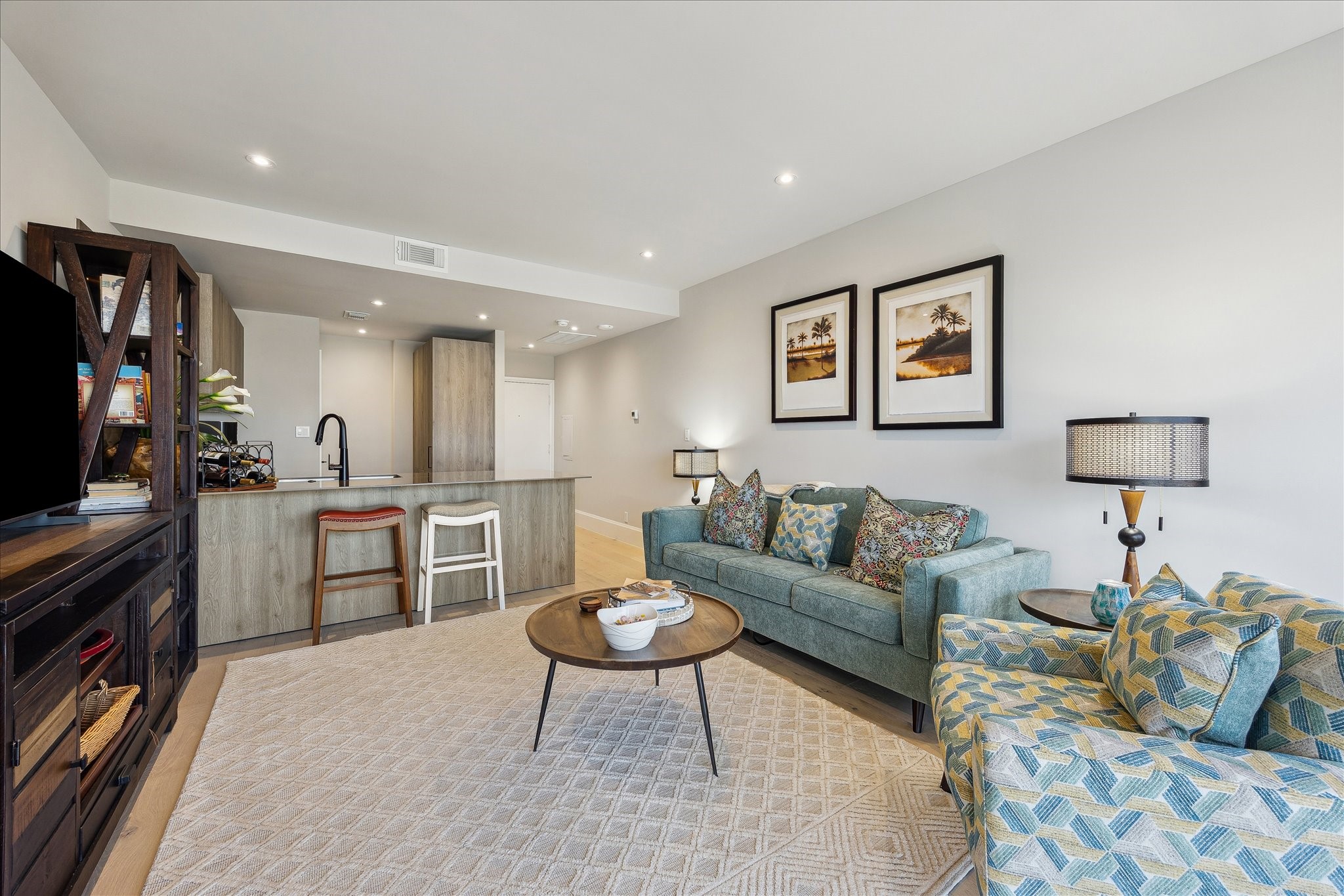 1701 Hermann Drive, Unit 22CE Houston, TX 77004 - Photo 17 of 37 a living room with furniture a flat screen tv and kitchen view