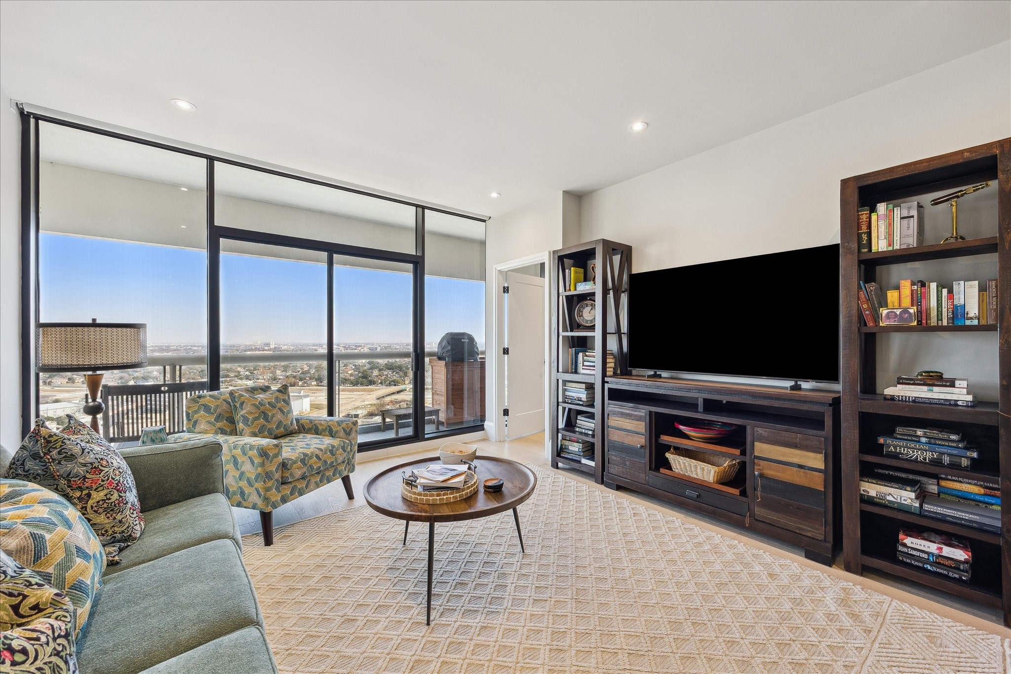1701 Hermann Drive, Unit 22CE Houston, TX 77004 - Photo 18 of 37 a living room with furniture and a flat screen tv