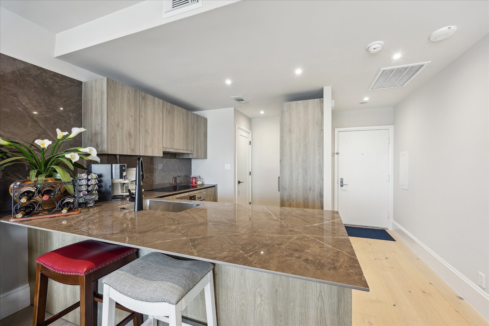 1701 Hermann Drive, Unit 22CE Houston, TX 77004 - Photo 19 of 37 a kitchen with sink refrigerator and cabinets