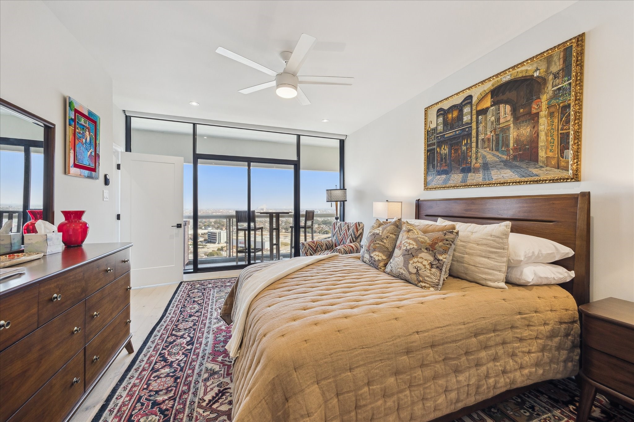 1701 Hermann Drive, Unit 22CE Houston, TX 77004 - Photo 22 of 37 a bedroom with a bed a dresser and next to a window