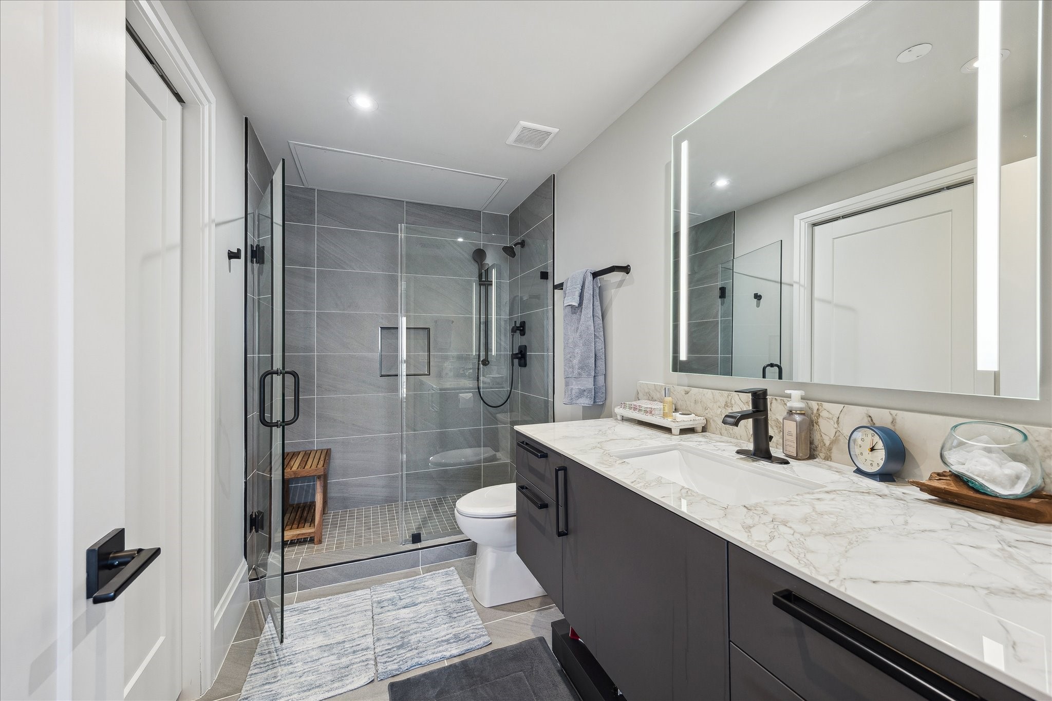 1701 Hermann Drive, Unit 22CE Houston, TX 77004 - Photo 23 of 37 a bathroom with a granite countertop sink mirror and double