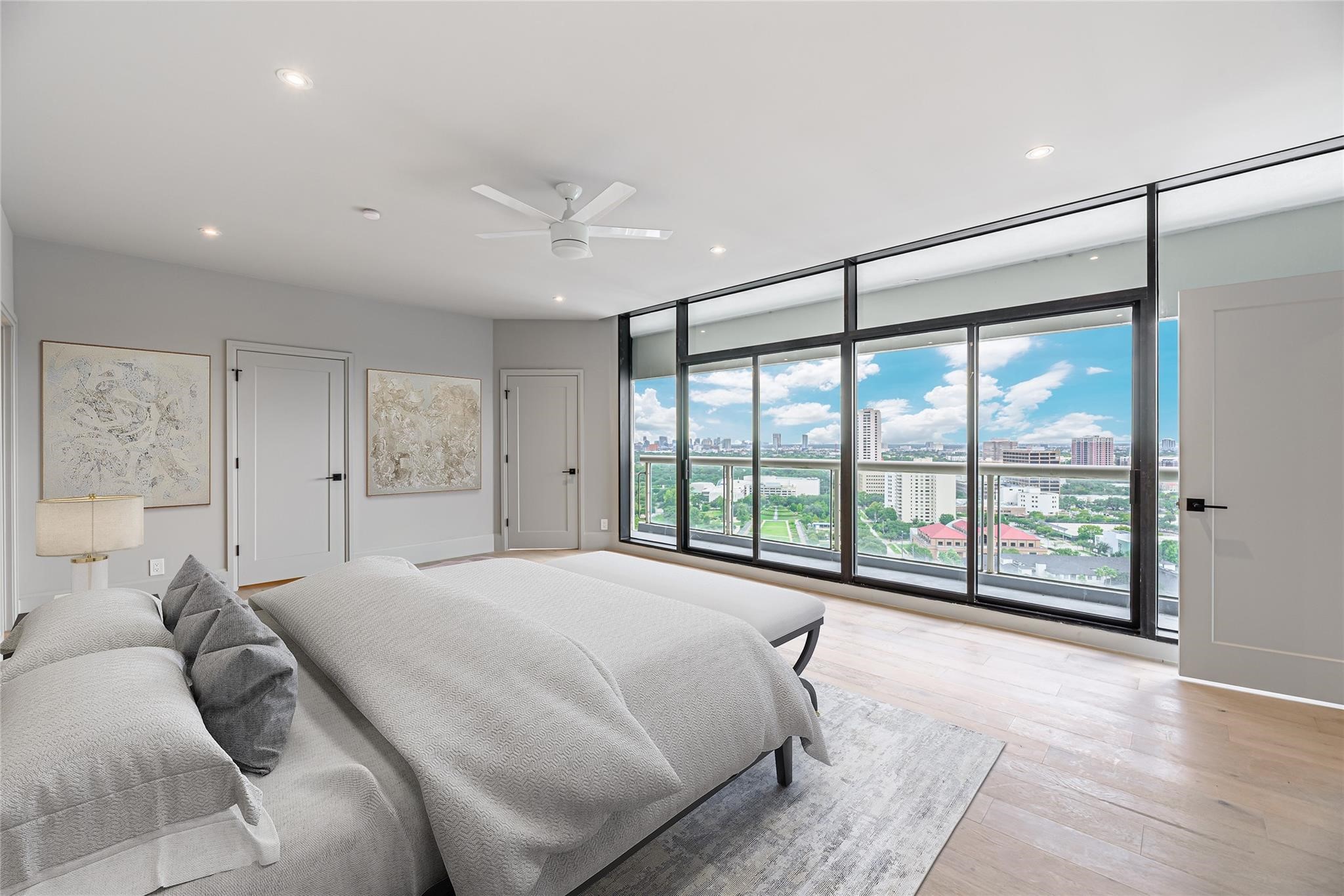 1701 Hermann Drive, Unit 22CE Houston, TX 77004 - Photo 9 of 37 a spacious bedroom with a large bed and a large window