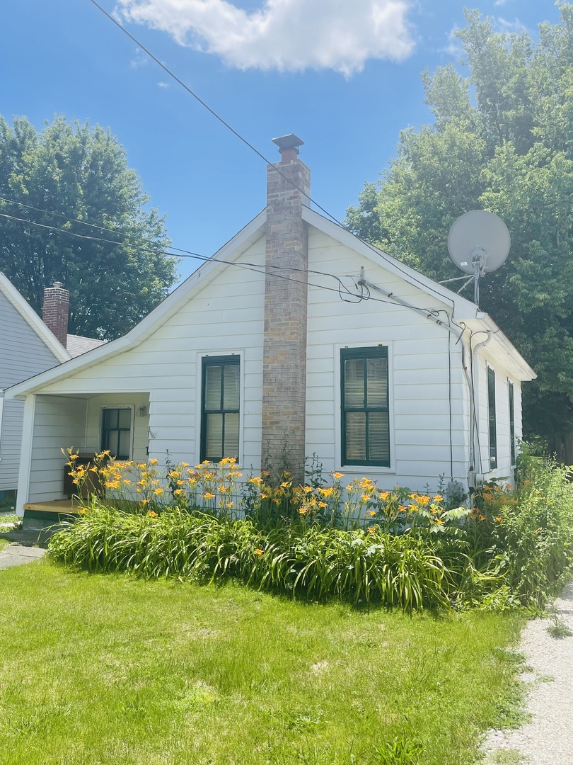 1213 East Main Street Streator, IL 61364 - Photo 1 of 18 a front view of house with a yard and potted plants