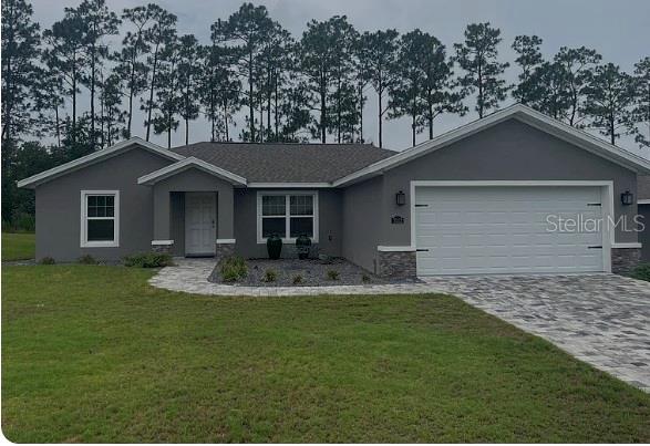 7052 Southwest 179th Ave Road Dunnellon, FL 34432 - Photo 1 of 11 a front view of a house with a yard and porch
