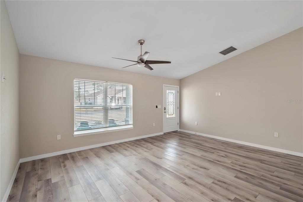 7052 Southwest 179th Ave Road Dunnellon, FL 34432 - Photo 13 of 42 a view of an empty room with wooden floor and a window