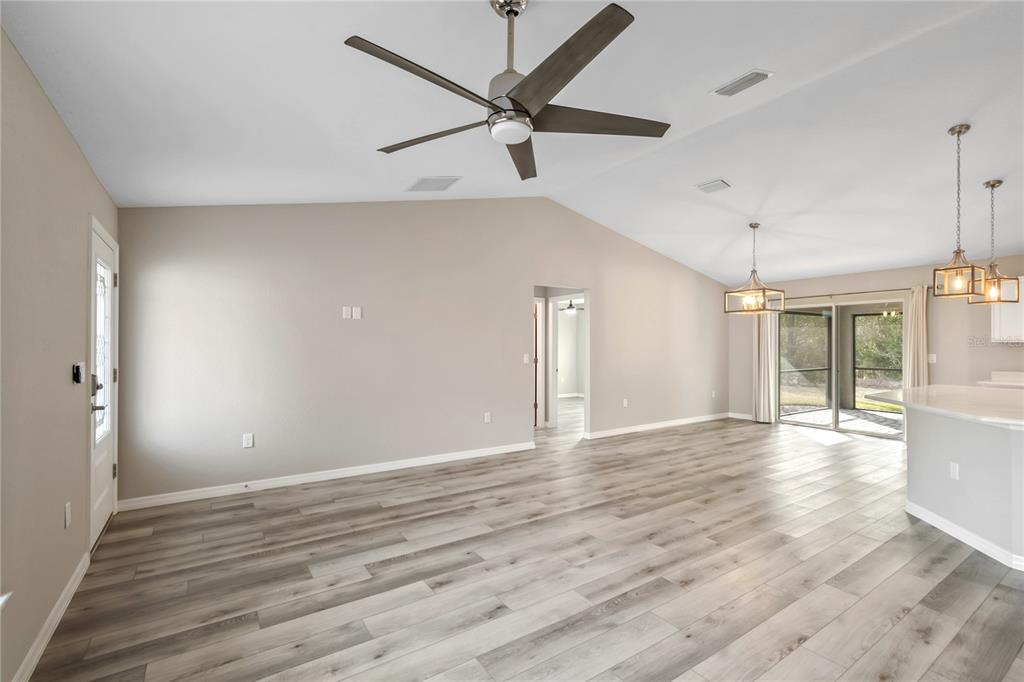 7052 Southwest 179th Ave Road Dunnellon, FL 34432 - Photo 14 of 42 a view of an empty room with window and wooden floor