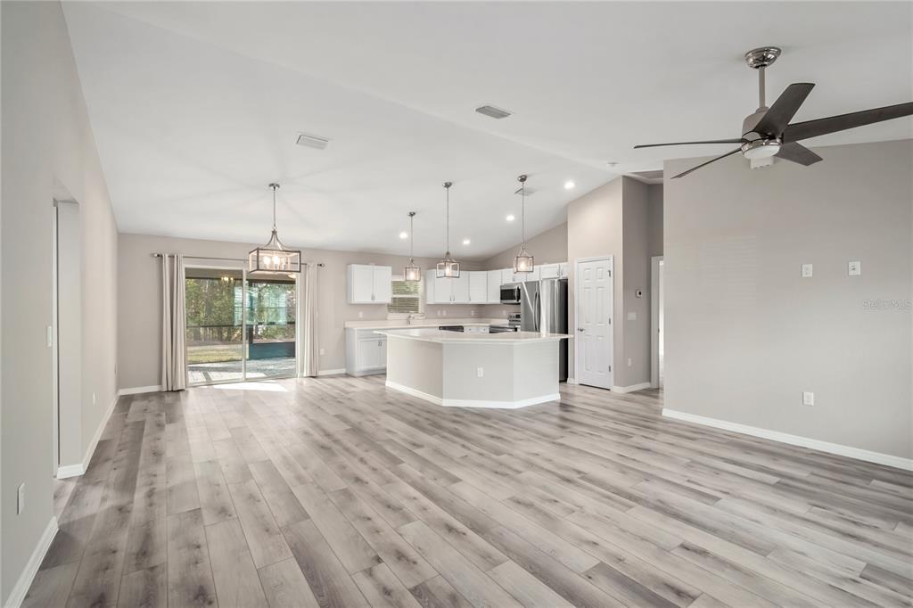 7052 Southwest 179th Ave Road Dunnellon, FL 34432 - Photo 15 of 42 a large white kitchen with wooden floors and kitchen view