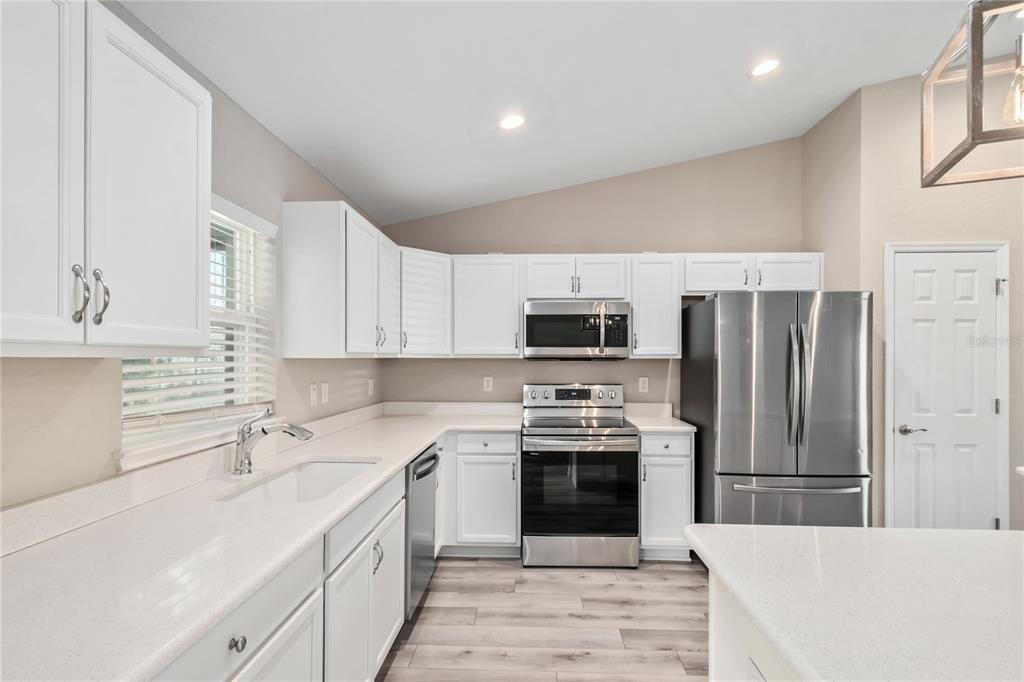 7052 Southwest 179th Ave Road Dunnellon, FL 34432 - Photo 22 of 42 a kitchen with stainless steel appliances a stove sink microwave and cabinets