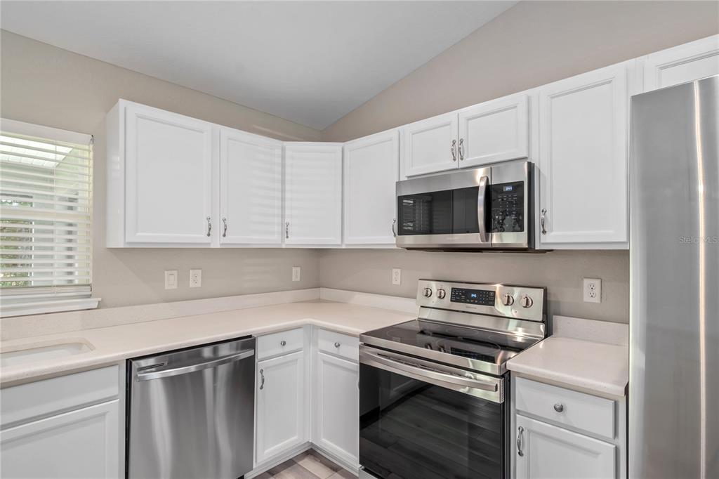 7052 Southwest 179th Ave Road Dunnellon, FL 34432 - Photo 24 of 42 a kitchen with stainless steel appliances granite countertop a sink a stove a microwave and cabinets