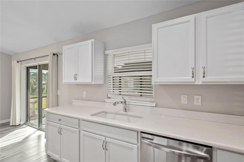 7052 Southwest 179th Ave Road Dunnellon, FL 34432 - Photo 25 of 42 a kitchen with stainless steel appliances granite countertop a sink and a white cabinets
