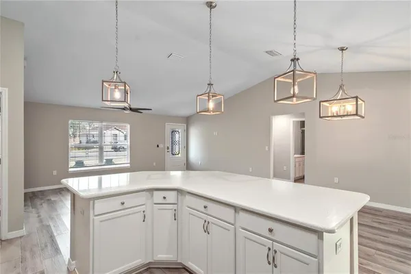 a kitchen with a sink a window and stainless steel appliances