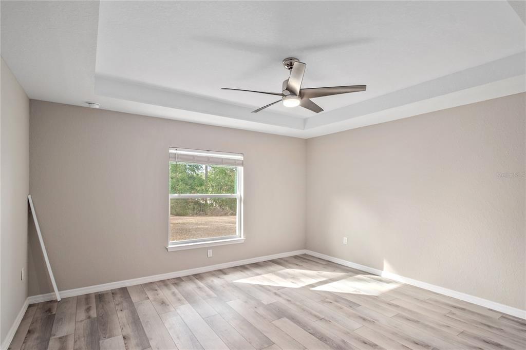7052 Southwest 179th Ave Road Dunnellon, FL 34432 - Photo 27 of 42 a view of empty room with wooden floor and fan
