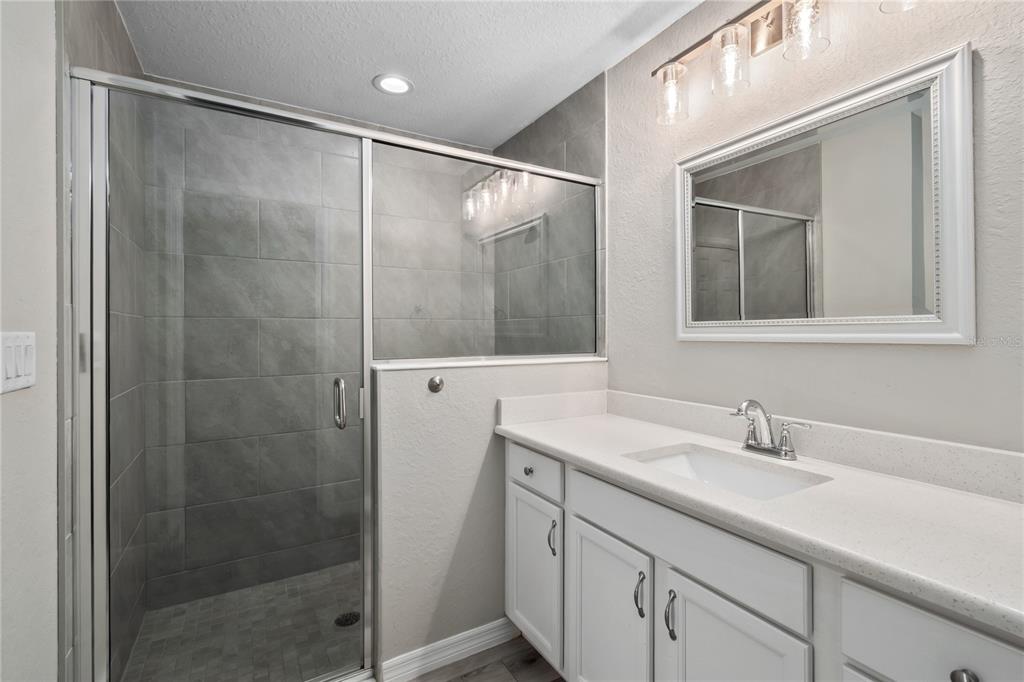 7052 Southwest 179th Ave Road Dunnellon, FL 34432 - Photo 30 of 42 a bathroom with a shower sink and mirror