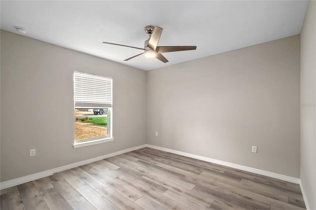 7052 Southwest 179th Ave Road Dunnellon, FL 34432 - Photo 35 of 42 an empty room with a window and a ceiling fan