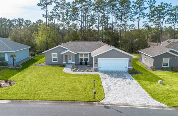 a aerial view of a house with swimming pool next to a yard