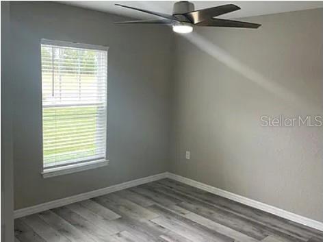 7052 Southwest 179th Ave Road Dunnellon, FL 34432 - Photo 7 of 11 a view of an empty room with wooden floor and a window