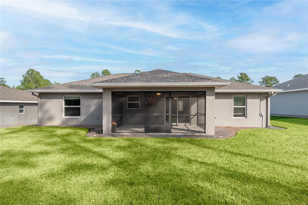 7052 Southwest 179th Ave Road Dunnellon, FL 34432 - Photo 9 of 42 a front view of a house with a yard and porch