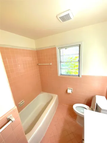 a view of a room with wooden floor and fan