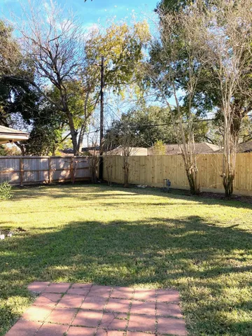 a view of a small yard with wooden fence